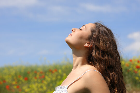 Woman breathing in a flowers field