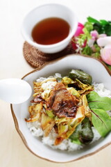 Chinese food, cabbage and green pepper stir fried with pork belly on rice 