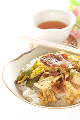 Chinese food, cabbage and green pepper stir fried with pork belly on rice with tea