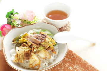 Chinese food, cabbage and green pepper stir fried with pork belly on rice 