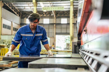 Caucasian handsome male industrial worker work in manufacturing plant.