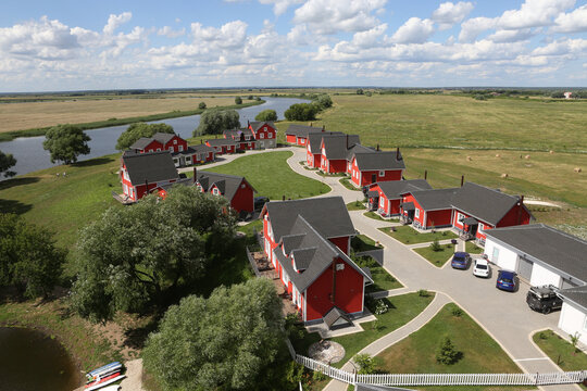 Fishing Village in Ryazan region, Russia. Russian scenic nature, landscape and red houses in Norwegian, Scandinavian style. Ryazan landmark. Summer scenery, view