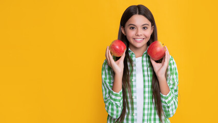 cheerful kid with apple on yellow background
