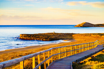 Obraz premium Beach with wooden path to sea water.