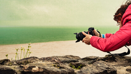 Woman with camera take photo of flowers