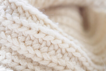 closeup beige knitted woolen fabric texture background