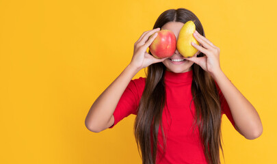 positive child with fresh apple and pear on yellow background