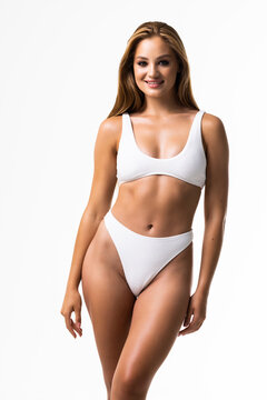 Smiling sporty woman in white underwear posing on studio background with copy space. Female beauty, sport, spa concept