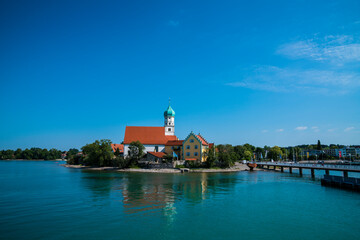 Fototapeta na wymiar Germany, City wasserburg at lake constance, panorama view from waterside to the houses and church of the village in summertime