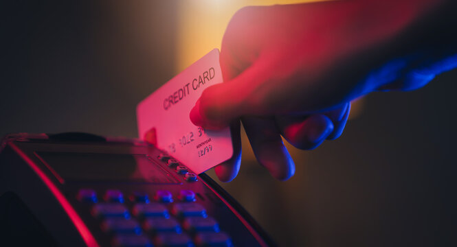 Hand using credit card and pay on card reader machine, Online shopping concept.