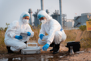 Ecologist taking samples of water with test tube from city river to determine level of contamination and pollution, Research conserve water and environment.