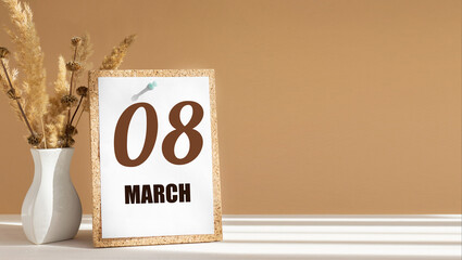 march 8. 8th day of month, calendar date.White vase with dead wood next to cork board with numbers. White-beige background with striped shadow. Concept of day of year, time planner, spring month