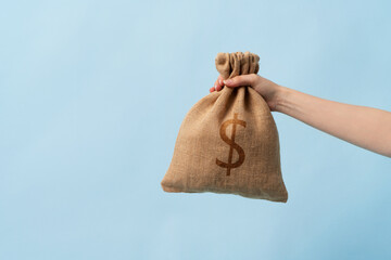 Full of cash dollar money bag on the blue background. Economic growth, price increase, inflation.