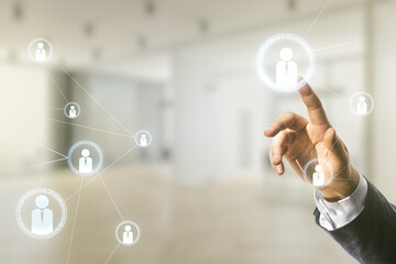 Double exposure of businessman hand working with social network icons on blurred office background. Networking concept