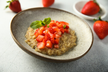 Healthy quinoa porridge with fresh strawberry