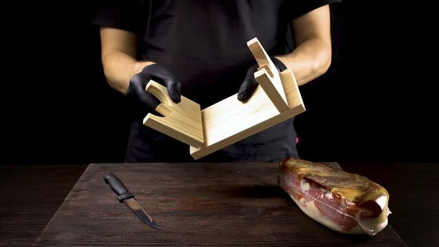 cortador prepares a stand for jamon