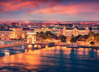 Spectacular summer view of famous Chain Bridge on the Danube river. Illuminated sunset in Budapest, Hungary, Europe. Traveling concept background..