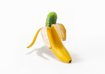 The banana peel contains a ripe green cucumber. Modern design. Modern Art. Creative collage. Isolated