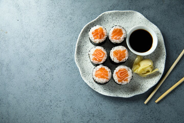 Homemade salmon maki rolls with soy sauce