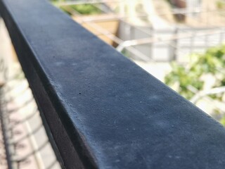 A clear shot of a balcony railing.  Well blurred background.