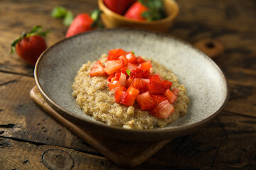 Healthy quinoa porridge with fresh strawberry