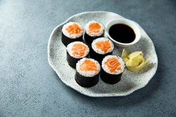 Homemade salmon maki rolls with soy sauce