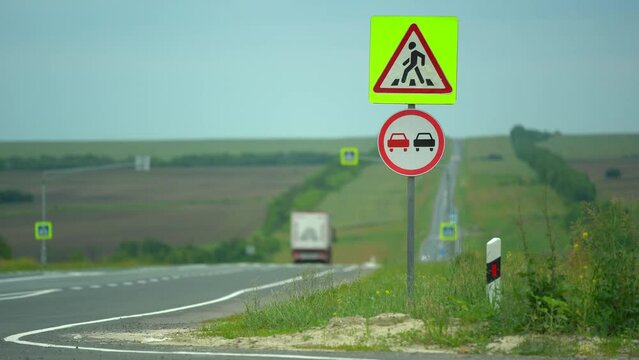 Traffic sign in highway with crossroad. Danger part of the road. Attention sigh no overtaking. warning drivers on the road. Technology in safety people life. Summer day. Safety concept. People's life