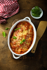 Traditional homemade lasagna with fresh basil