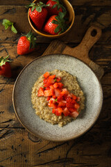 Healthy quinoa porridge with fresh strawberry