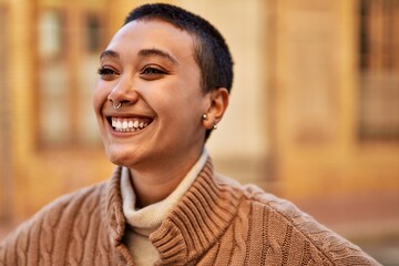 Beautiful hispanic woman with short hair smiling happy outdoors