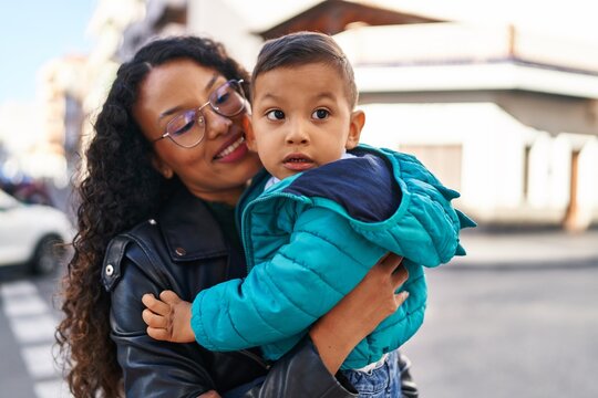 Mother and son hugging each other standing at park