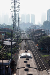 top view of the roof of the train passing between people's houses