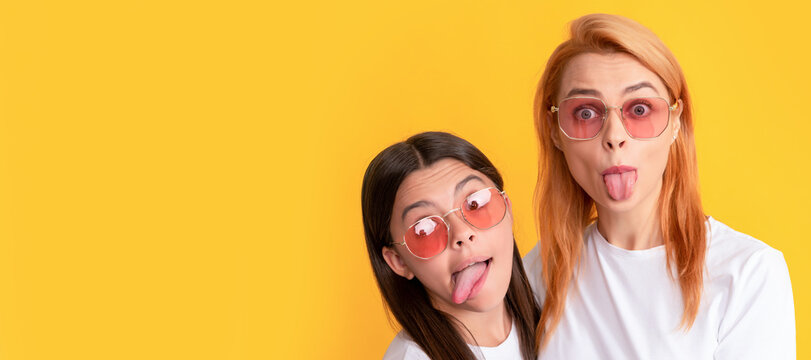 Mother and daughter child banner, copy space, isolated background. happy family portrait of single mother and daughter in glasses showing tongue, fun tongue crazy.