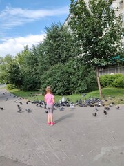 Little girl and a flock of doves