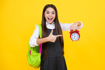 Back to school. Teenager schoolgirl with bag hold clock alarm, time to learn. School children on...