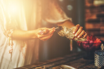 incense in a woman hand, ceremony space. - obrazy, fototapety, plakaty
