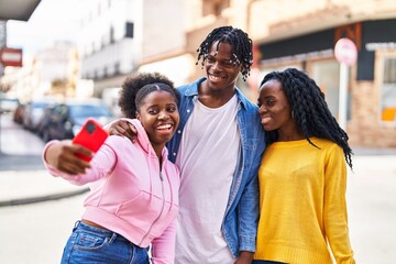 African american friends standing together making selfie by the smartphone at street