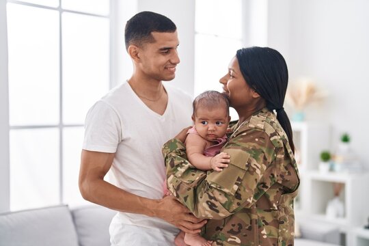Hispanic family army soldier hugging each other at home