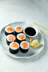 Homemade salmon maki rolls with soy sauce