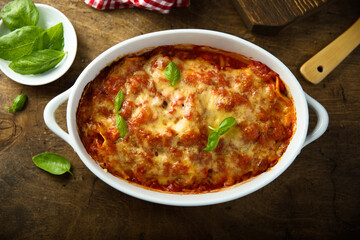 Traditional homemade lasagna with fresh basil