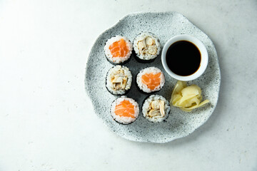 Obraz na płótnie Canvas Healthy sushi rolls with salmon and eel