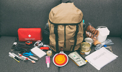 The packed backpack with items needed for evacuation. Emergency kit. Set of necessary things in...