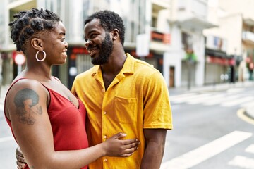 Young afircan american couple smiling happy and hugging at the city.