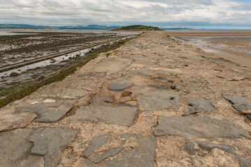 Selective focus on a section of the causeway across the Firth of the Forth to Cramond Island,...
