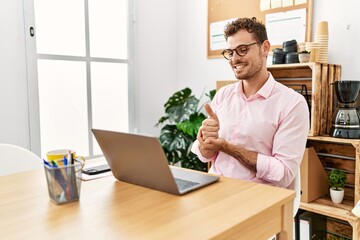 Young hispanic man having video call communicating with deaf sign language at office