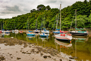 Fototapeta na wymiar Cramond, Scotland, UK – June 21 2022. Yachts, pleasure craft and leisure boats moored on the River Almond at low tide