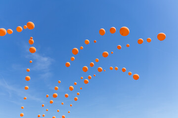 Orange balloons on a blue sky