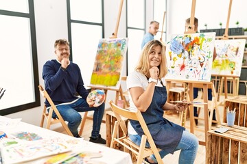 Group of middle age artist at art studio thinking worried about a question, concerned and nervous...