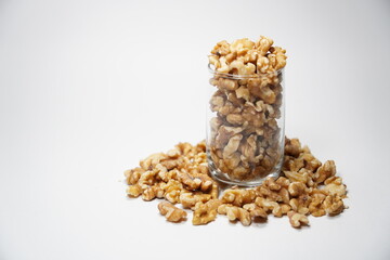 Walnuts spilling from the glass.