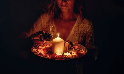 incense in a woman hand, incense smoke on a black background.